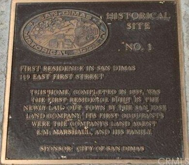 Historical Site plaque on sidewalk in from of the 