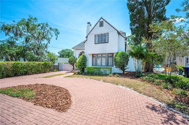 Front of home with brick circle driveway