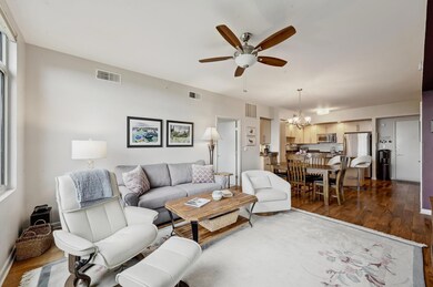 Living room featuring a chandelier, a ceiling fan
