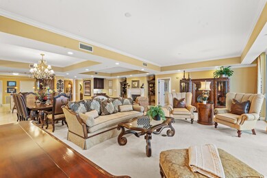 Carpeted living room featuring a raised ceiling, o