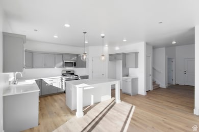 KITCHEN W/ WHITE PAINTED SHAKER CABINETS & A WARM STAINED ISLAND!  TILE BACKSPLASH & PENDANT LIGHTS! (PICTURE OF PREVIOUS BUILT HOME-COLORS AND MATERIALS MAY VARY)