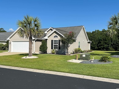 View of front of house with a garage, a front lawn, and driveway