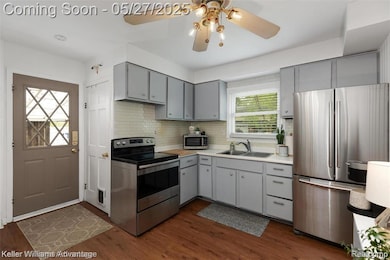 Remodeled kitchen with freshly painted cabinets, new flooring and stainless steel appliances and new luxury vinyl plank flooring