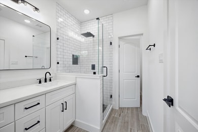 The primary suite also features a frameless subway