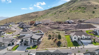 Aerial view of property's location featuring nearby suburban area and a mountain backdrop