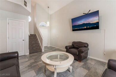 Living area featuring stairway, baseboards, and lo