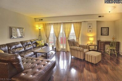 Wonderful entertaining/relaxing space in the living room area.  Note the newer sliding glass doors to the north/lake-facing view.  The balcony has newer stone flooring!