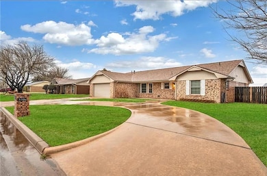 Single story home featuring a garage and a front y