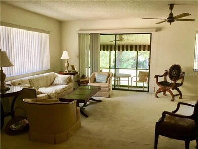 Great room with sliders to an enclosed Florida roo