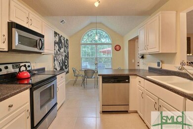 Kitchen with newer porcelain tile and updated stai