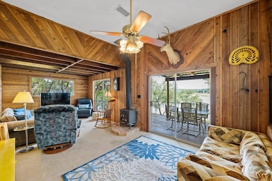 Living area featuring wood walls, a wood stove, h