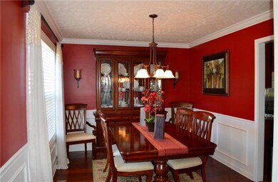 Spacious formal dining room features pretty chair rail and hardwood floors! 