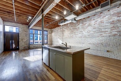 Kitchen with a sink, brick wall, stainless steel 