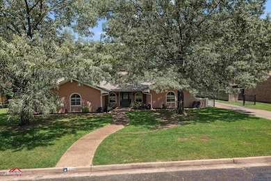 View of front facade featuring brick siding and driveway