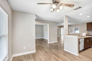 Dinette area with view into kitchen, living area and office