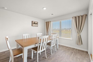 Dining room featuring light wood finished floors and baseboards