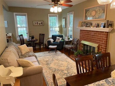 Family Room with brick fireplace, ceiling fan, & v