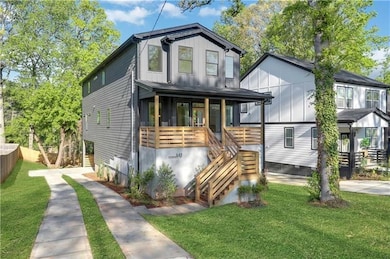 View of front of property with stairs, a front lawn, and a porch