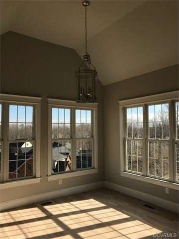Dining area off of kitchen with cathedral vaulted 