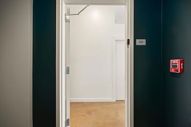Hall with baseboards and light colored carpet