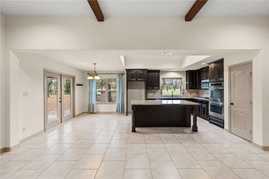 Kitchen featuring stainless steel appliances, beam