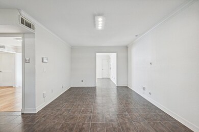 Spare room featuring baseboards, visible vents, an