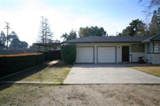Two car garage w/ side yard covered parking, which
