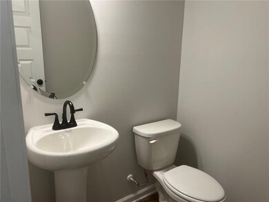 Half bathroom featuring toilet and baseboards