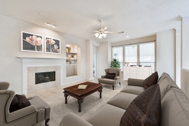 Spacious family room with gaslog fireplace and built-in entertainment center opens to the sunroom, kitchen and breakfast. virtually staged