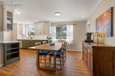 Dining room featuring sink, crown molding, and har
