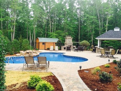 Rear view with In-Ground pool and Spacious Living Area, Storage Building