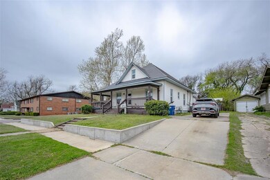 View of front of house featuring driveway, covered