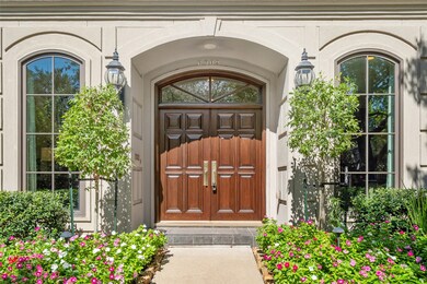 Welcoming gas lanterns and grand double wood doors