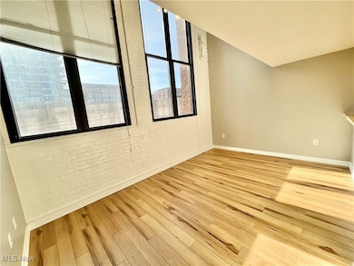 Living room with brick wall and light wood finished floors