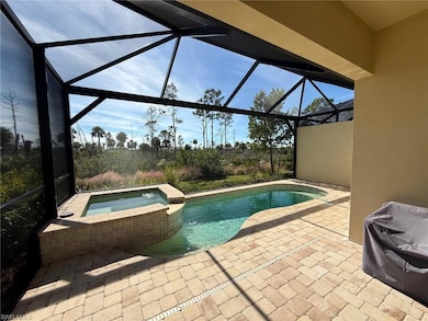 View of pool with a sunroom, a patio, and a lanai