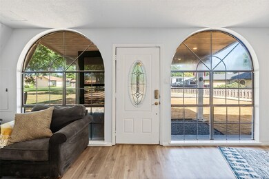 Entryway with wood finished floors and a textured ceiling