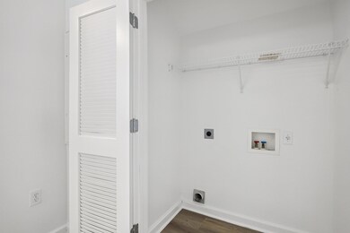 Laundry room featuring electric dryer hookup, dar