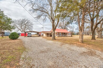 Ranch-style home featuring a carport and a porch