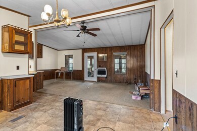 Large living room that surrounds the kitchen and dining area.