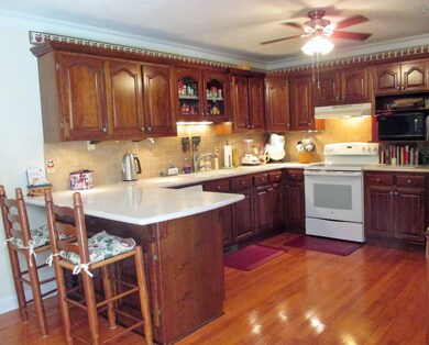 This kitchen was built for use! Very functional with plenty of counter space, tile back splash and even a place for your cookbooks. 
