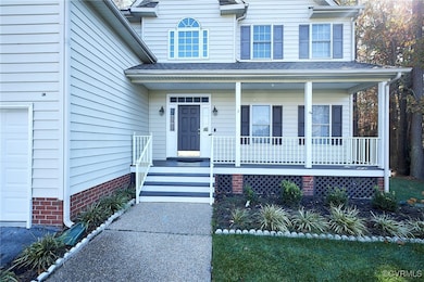 View of front facade with a garage and covered por