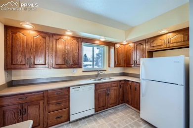 Kitchen with sink and white appliances