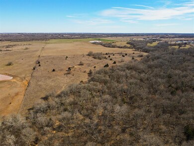 Aerial view of property and surrounding area featuring rural landscape