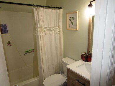 Bathroom featuring toilet, vanity, and shower / bath combination with curtain