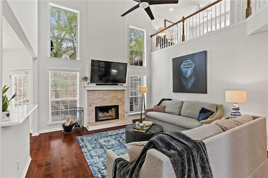Living area featuring a high ceiling, dark wood fl