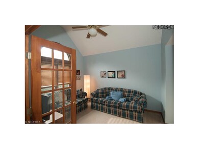 French doors open off foyer into a den featuring a