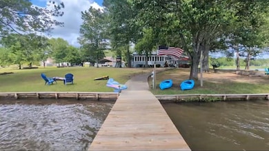 Dock area with a water view and a yard