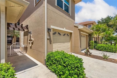 View of home's exterior with a garage, a gate, stu