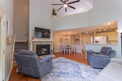 Living room with a stone fireplace, wood finished 