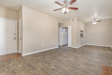 Spare room with ceiling fan, dark hardwood / wood-